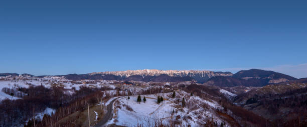 Panoramic winter view of Piatra Craiului National Park, mountain range in the Southern Carpathians in Romania. Hiking above the clouds. Majestic nature scenery with snowy mountains in background Panoramic winter view of Piatra Craiului National Park, mountain range in the Southern Carpathians in Romania. Hiking above the clouds. Majestic nature scenery with snowy mountains in background zarnesti stock pictures, royalty-free photos & images