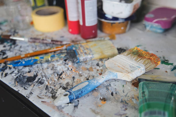 istock Brushes and acrylic paints on the work table of an artist painter. 1455661663