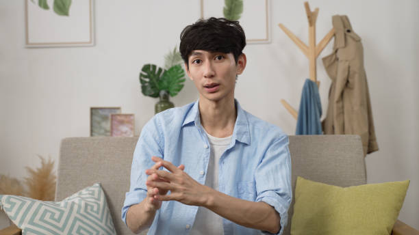 istock webcam view asian male creative worker working from home is expressing ideas to client with hand gestures in a virtual meeting via video call in the living room 1455663427