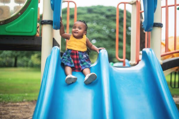 istock Playing on the Slide in the Park 1455663748