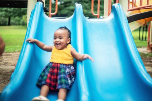 istock Playing on the Slide in the Park 1455663770