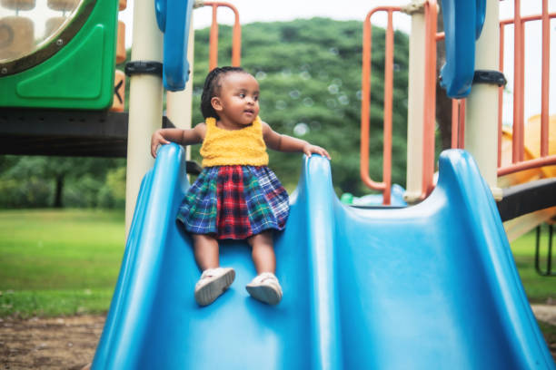 istock Playing on the Slide in the Park 1455663772