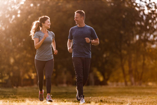 istock Happy athletic couple talking and running in nature. 1455664793