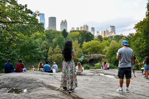 New York, Manhattan - October 7, 2022: Rocks in Central Park offer a good view of the Manhattan skyline.
