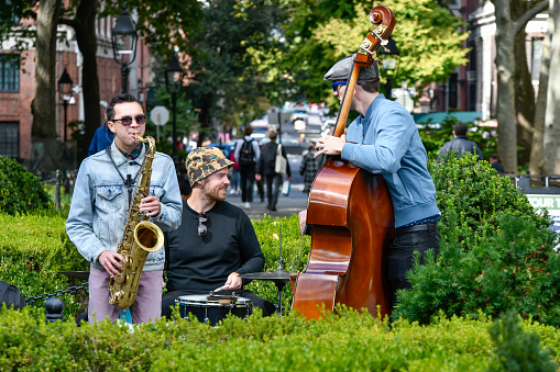 New York, Manhattan, October 8, 2022: Visitors to Washington Square Park with musicians, artists and tourists.