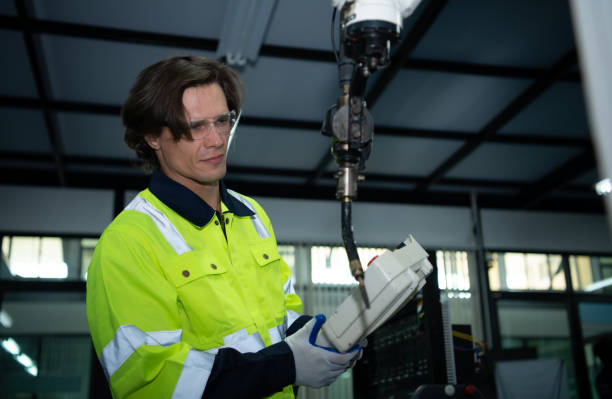 istock A big welding robot is being inspected and controlled by a robotics engineer. After the machine has been used for the specified amount of time. 1455665175