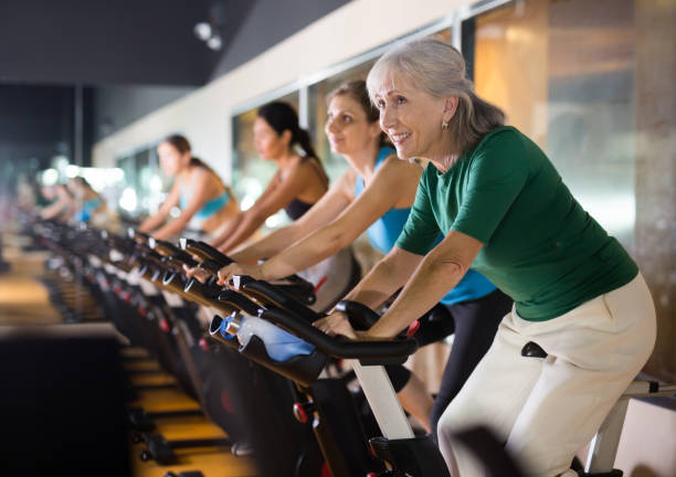 istock Mature woman taking cycling class at gym 1455667809