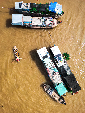 overhead view on colorful boats of merchants selling at traditional floating market in can tho in mekong delta in south vietnam
