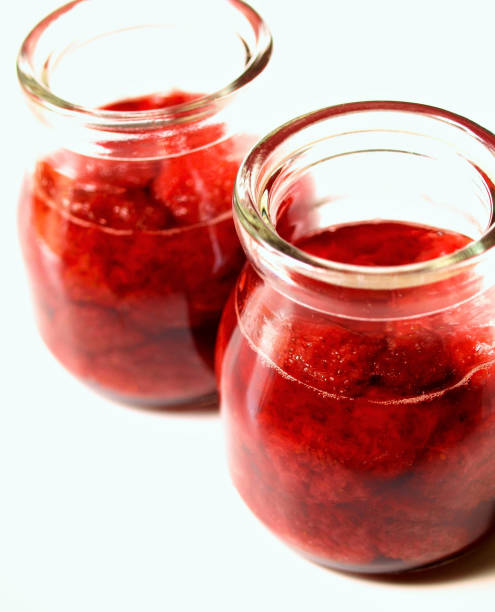 istock strawberry jam in a glass jar. 1455669700