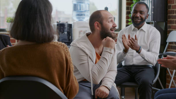 istock Man doing handshake with people after sharing progress and success at a group meeting 1455671750