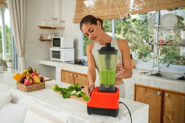 istock Woman preparing healthy smoothie after workout 1455672196