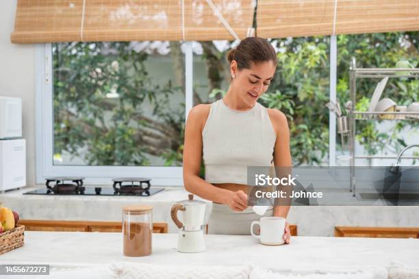 Smiling Woman Adding Protein Powder In A Coffee Stock Photo - Download Image Now - Protein Drink, Protein, Talcum Powder