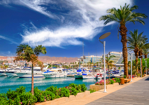 Marina and promenade with pleasure boats, surrounding hotels and shopping places in tourist resort of the Middle East
