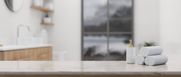istock Mockup space on white marble tabletop over blurred background of luxury white bathroom 1455672930