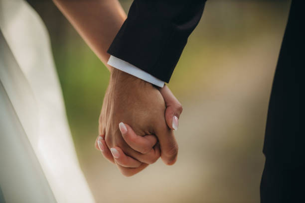 istock Closeup of a couple holding hands 1455673451