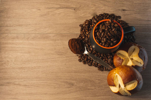 istock Top view of roasted coffee beans in a cup with biscuits on a table 1455673893