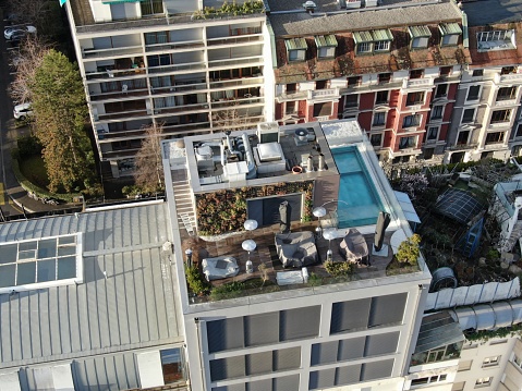 Aerial shot of a rooftop with a swimming pool on an upscale apartment building