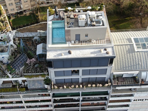 Aerial shot of a rooftop with a swimming pool of an upscale apartment building
