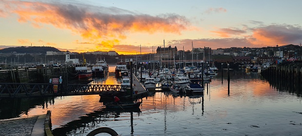 scarborough, United Kingdom – December 12, 2021: An aerial view of port with boats in Scarborough during sunset