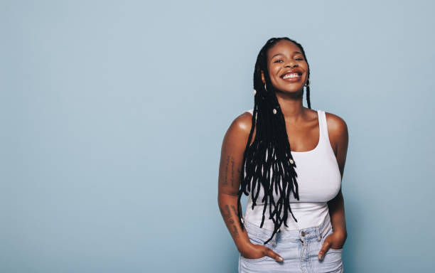 istock Stylish woman smiling while standing in a studio 1455676050