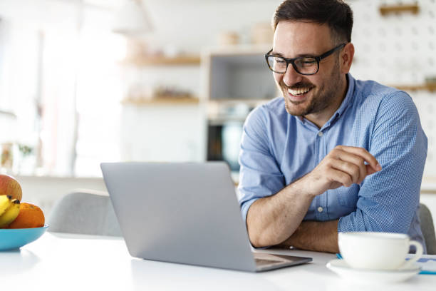 istock Happy businessman reading an e-mail on laptop at home. 1455676261