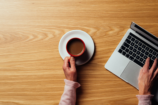 Top down view of a woman working at her desk.