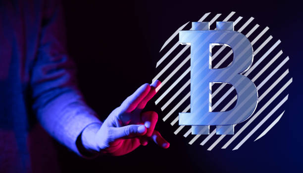istock Person presenting a virtual projection of the cryptocurrency symbol 1455677217