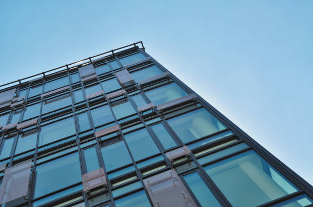 istock blue glass wall of office building mirror reflection 1455677245