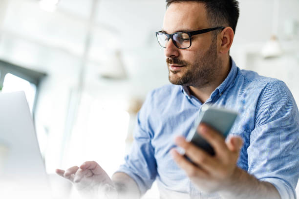 istock Young businessman working on wireless technology at home office. 1455677519