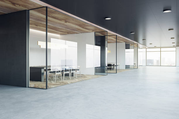 istock Perspective view on stylish office hall with city view from window background and modern interior design meeting rooms with dark furniture on wooden floor behind glass walls. 3D rendering 1455677952