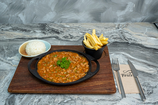 A platter with traditional Turkish meat soup and french fries