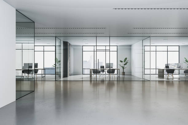 istock Front view on modern spacious sunlit office cabinets with stylish work place and city view background from panoramic windows in minimalistic interior design business center hall. 3D rendering 1455679130