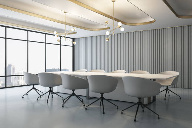 istock Perspective view on huge empty meeting table surrounded by white modern chairs in conference room with minimalistic interior design and city view from panoramic window on background. 3D rendering 1455679378
