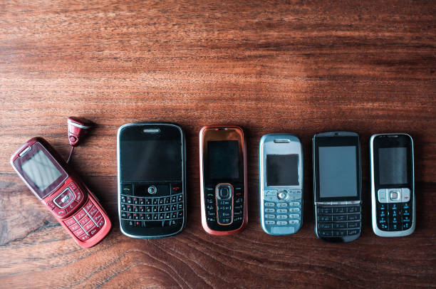 istock Top view of old model mobile phones on a brown table 1455680227