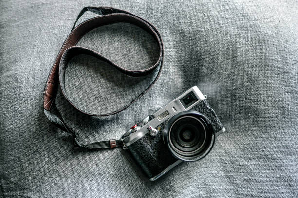 istock Top view of a vintage camera on a grey fabric surface 1455680247