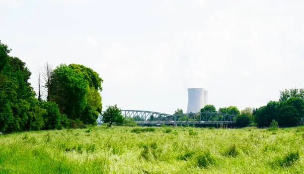 A nuclear power plant in Grohnde with cooling towers and surrounding landscape