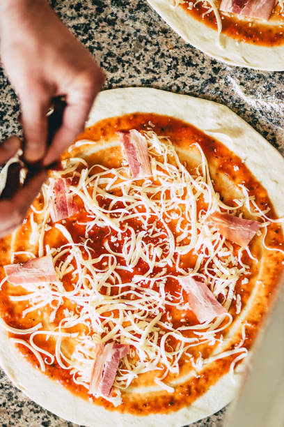 istock Closeup of a man preparing a pizza 1455682205