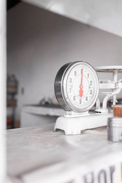A weighing analog scale is resting on a tortilleria counter. Concept of traditional corn tortillas preparation