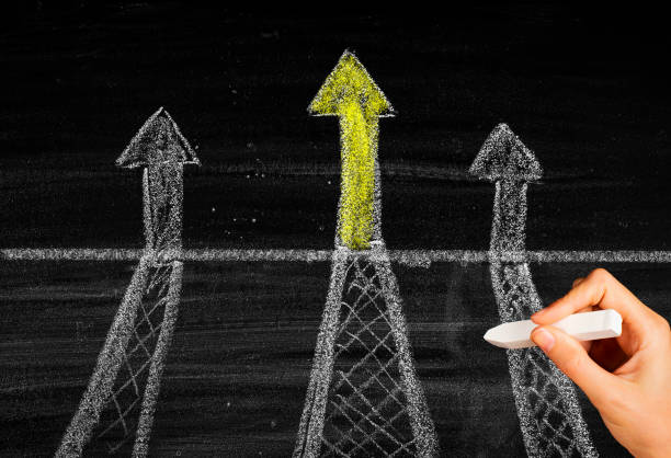 istock Leadership concept with arrows on chalkboard 1455684526