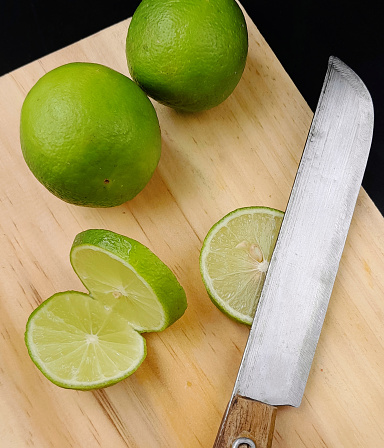 lime wedges on a wooden cutting board