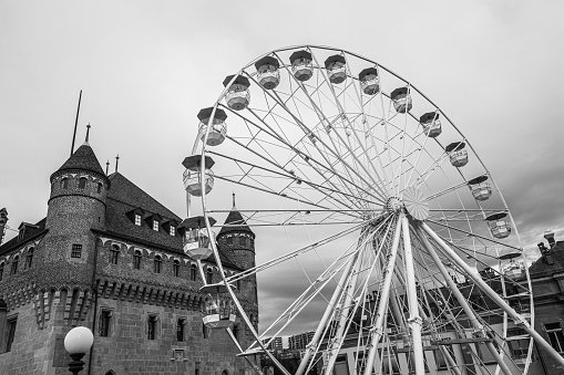 Lausanne, Switzerland – December 22, 2022: A Ferris wheel surrounded by buildings in Lausanne