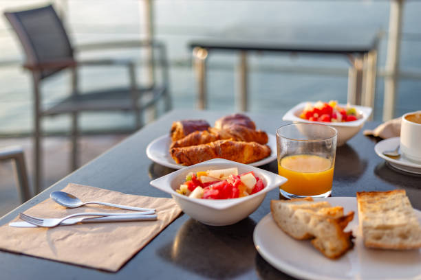 istock Table with breakfast on balcony facing the sea. Hotel breakfast 1455686736