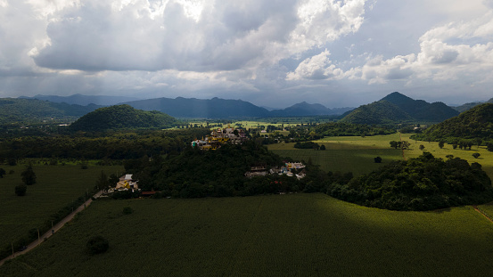 Aerial photograph of the Simalai Songtham Temple surrounded with farmlands and hills, Khao Yai, Pak Chong, Thailand.