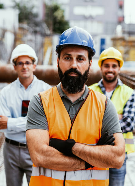 istock Engineers on construction site, looking at camera and smiling. Employment during recession 1455689013