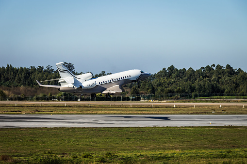 Porto, Portugal – December 17, 2016: A Dassault Falcon 7X business jet taking off from Porto International Airport, in Portugal