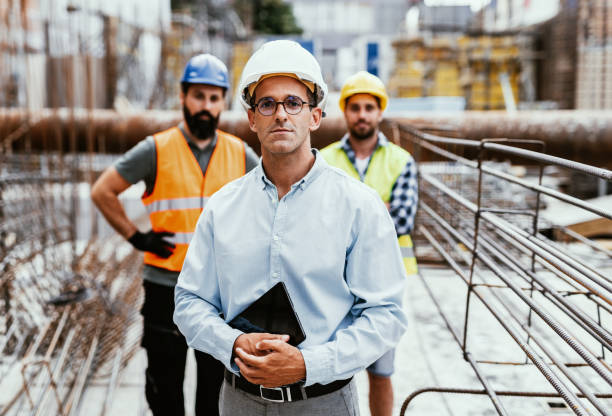 istock Engineers on construction site, looking at camera and smiling. Employment in housing and real estate sector 1455689641