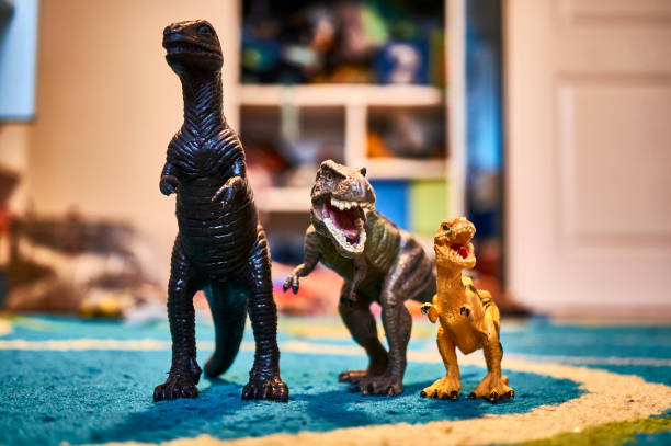 istock Spinosaurus and dead dinosaur figurines on the carpet 1455690126