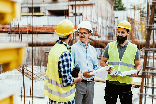 Candid shot of engineers and contractors on construction site