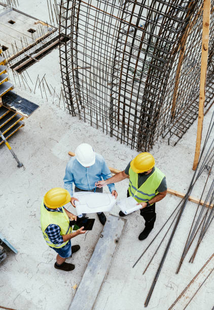 Engineers on construction site, high angle view of employees in construction industry stock photo