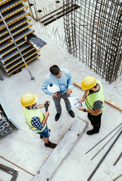 istock Unrecognisable Engineers on construction site, high angle view of employees in construction industry 1455690548